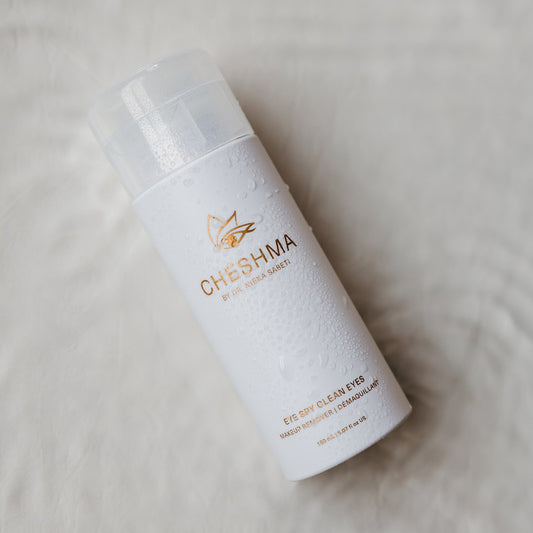 A bottle of white cheshma makeup remover placed on a clean, white surface, showcasing its sleek design and minimalist aesthetic.