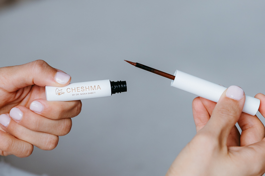 Thin liquid eyeliner applicator and vial from clean, eye-safe beauty brand CHESHMA.