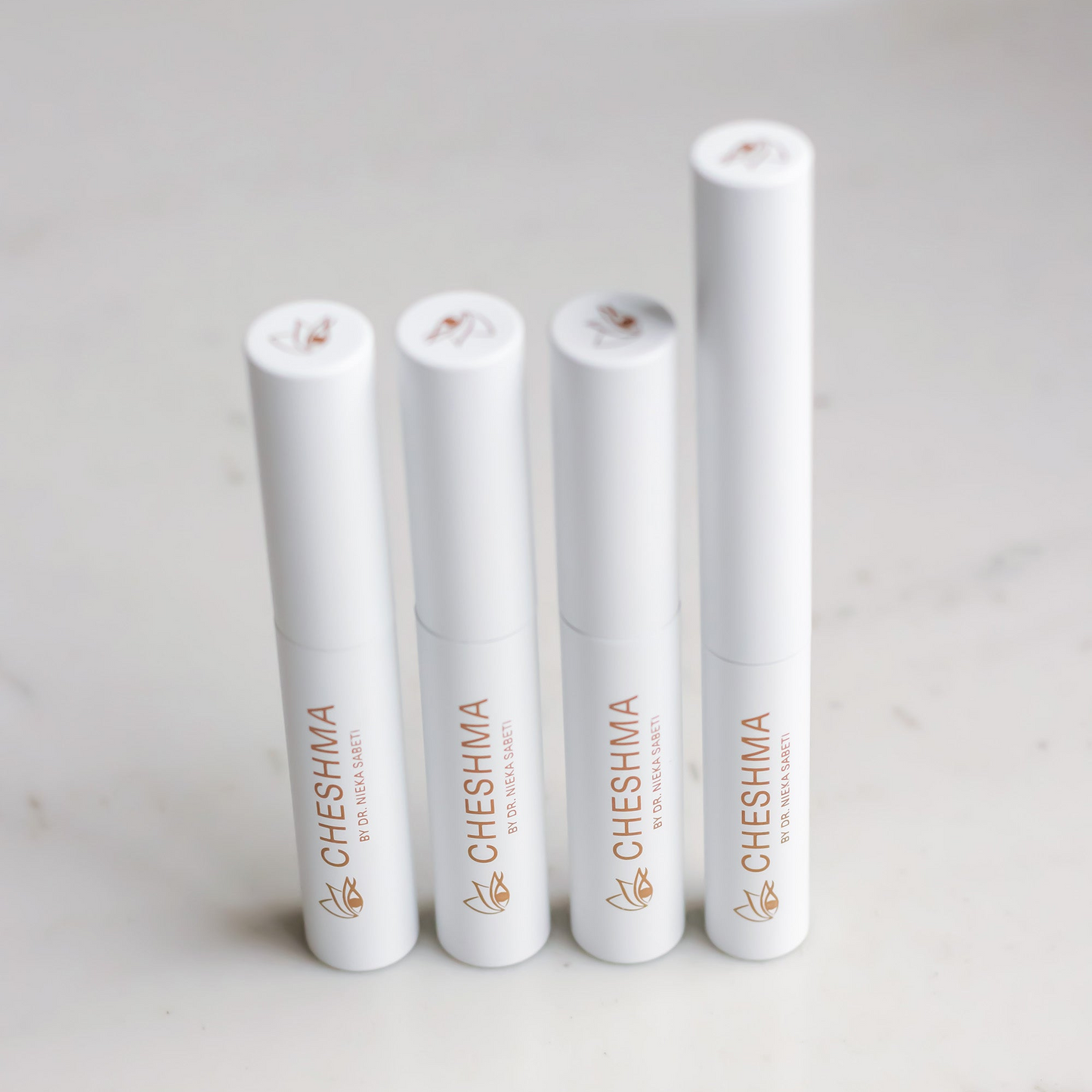 Cheshma white vials on marble countertop