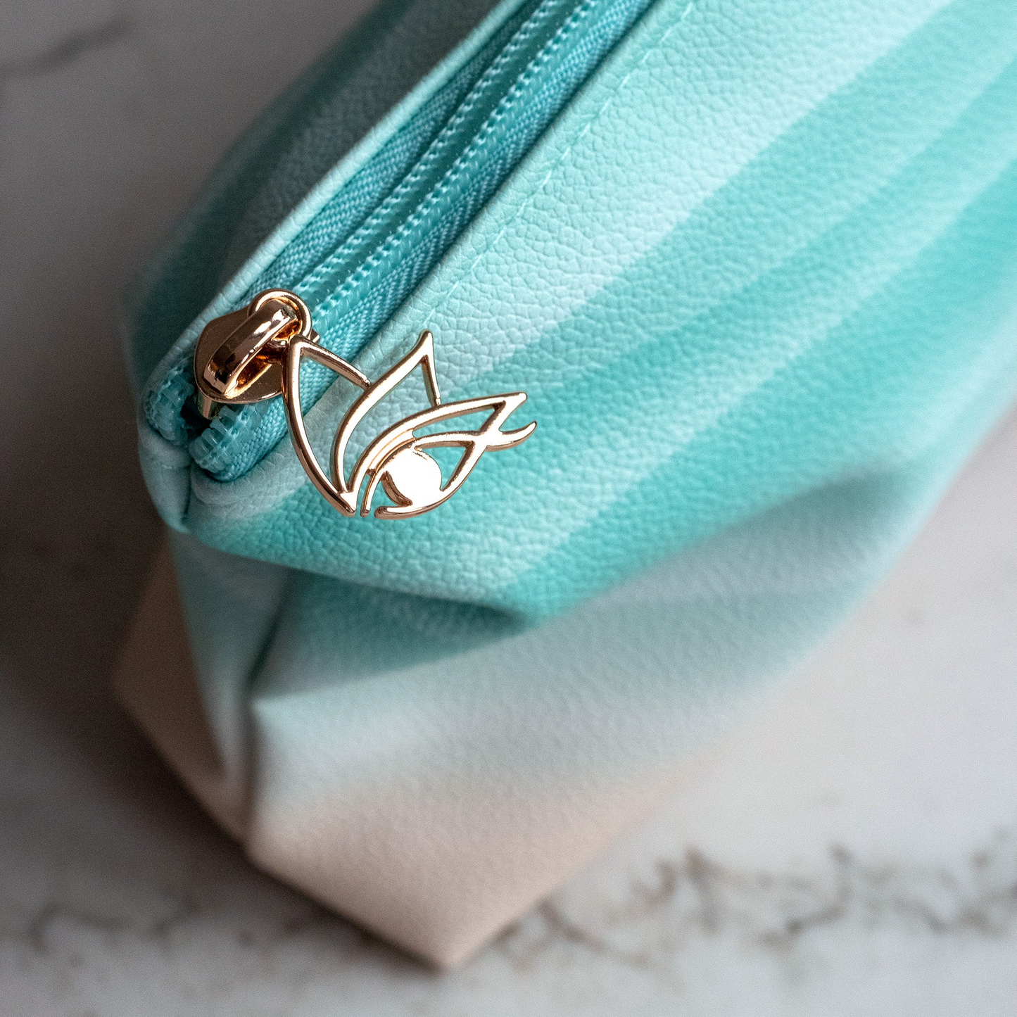 Cheshma cosmetic makeup bag with eye logo and blue teal wave pattern