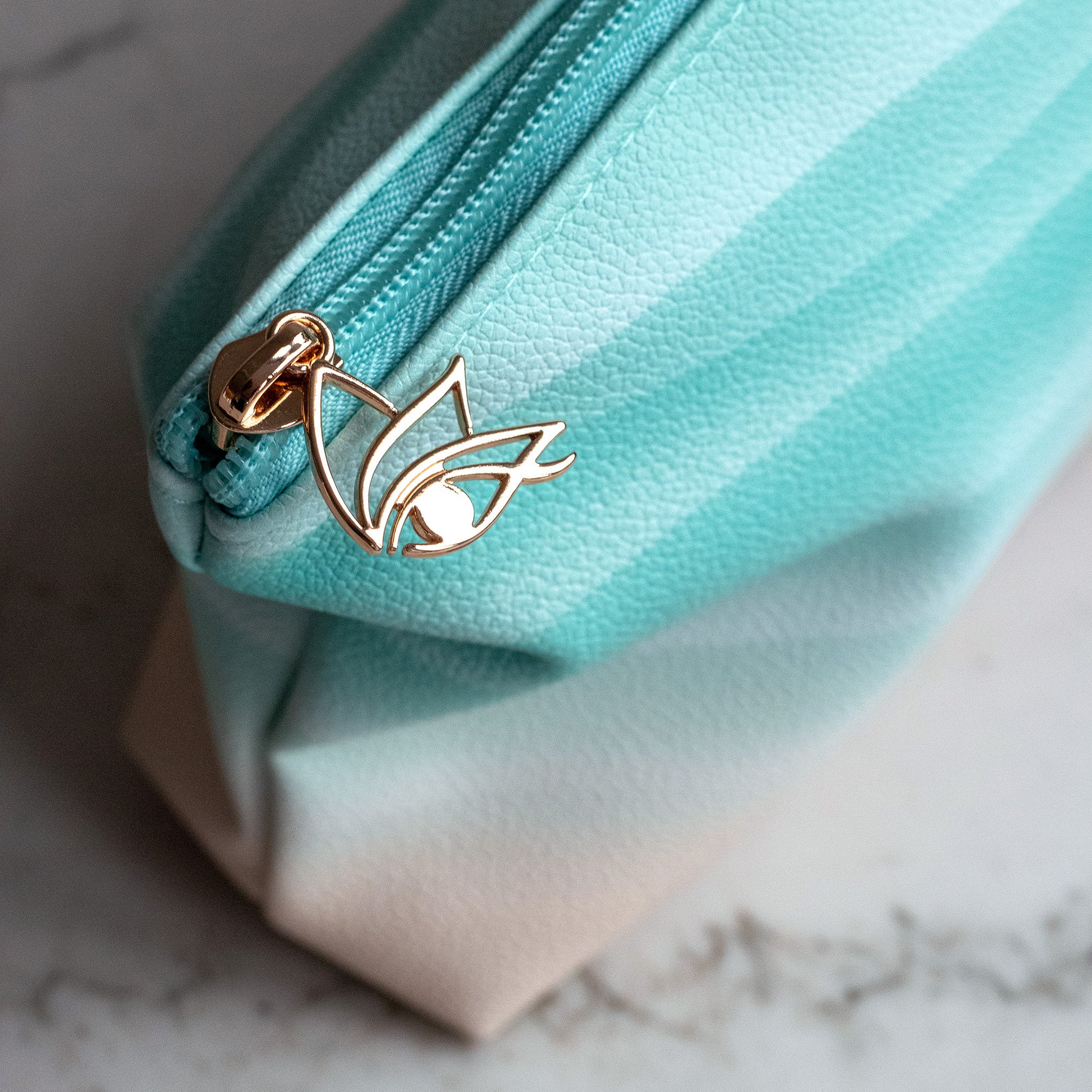 Cheshma cosmetic makeup bag with eye logo and blue teal wave pattern